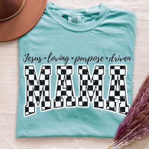 May include: A light blue t-shirt with the text "Jesus loving purpose driven" above the word "MAMA" in black and white checkered font.