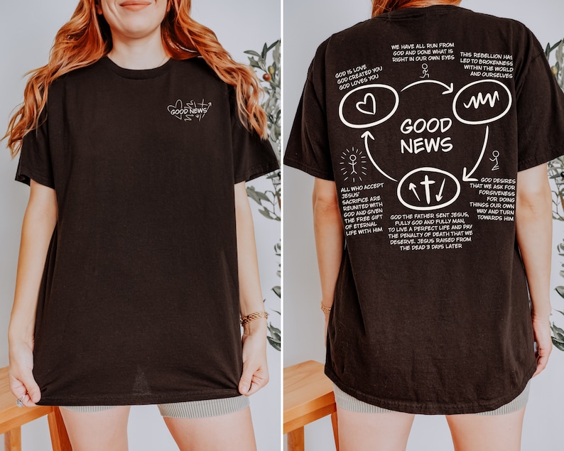 May include: Black t-shirt with a white graphic design on the back. The graphic features a circle with the words "Good News" in the center. The circle is surrounded by arrows and text about God's love and forgiveness.