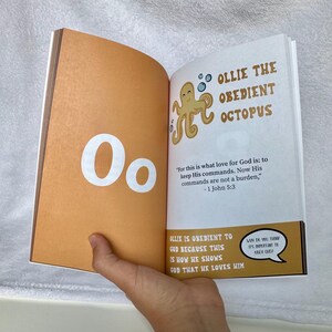 May include: A children's book page with the letter O and an illustration of an octopus. The text reads "Ollie the Obedient Octopus" and includes a Bible verse about obedience.