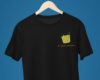 May include: Black t-shirt featuring a graphic of a glass of iced water with a lime wedge and a straw. The text "5 o'clock somewhere" is printed below the glass.