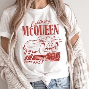 a woman wearing a t - shirt with a picture of a car on it