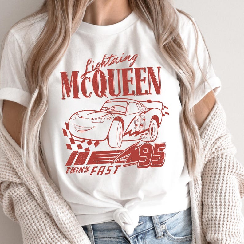 a woman wearing a t - shirt with a picture of a car on it