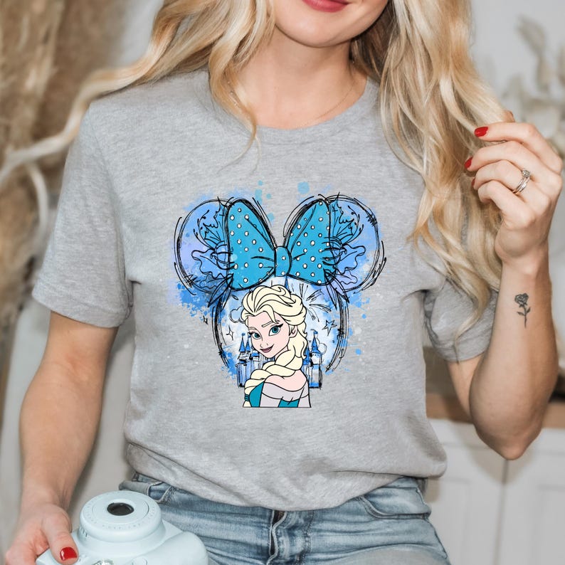 a blonde woman with a blue butterfly on her shirt
