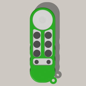 May include: A green remote control with six round buttons and a white circular button at the top. The remote has a small loop at the bottom.