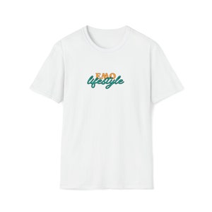 May include: White t-shirt featuring the text "EMO lifestyle". The word "EMO" is in orange, and "lifestyle" is in teal with a teal outline. The shirt has a crew neck and short sleeves.