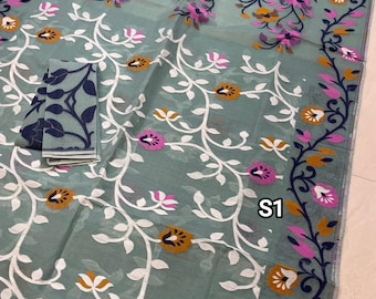 May include: A light blue saree with a white floral pattern and a dark blue border. The saree has a pink and orange floral design throughout. The saree is labeled "S1".