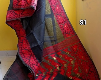 May include: Black and red patterned saree with a gold border. The saree is draped over a yellow wall with the text "S1" in the corner.