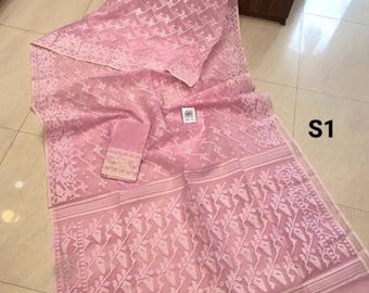 May include: A light pink sheer fabric garment featuring an intricate woven floral pattern throughout the material. The textile includes a distinct border with horizontal stripes and a separate folded piece of matching fabric with the text S1.
