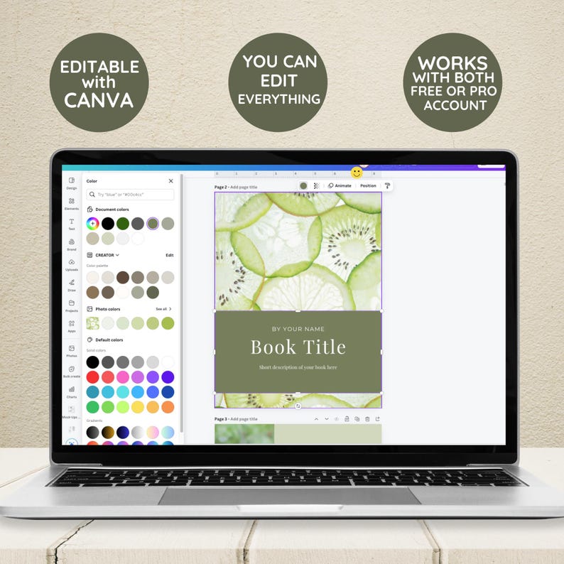 May include: A laptop screen displaying a Canva design template for a book cover. The cover features a green background with a photo of kiwi slices and the text "BY YOUR NAME" and "Book Title".