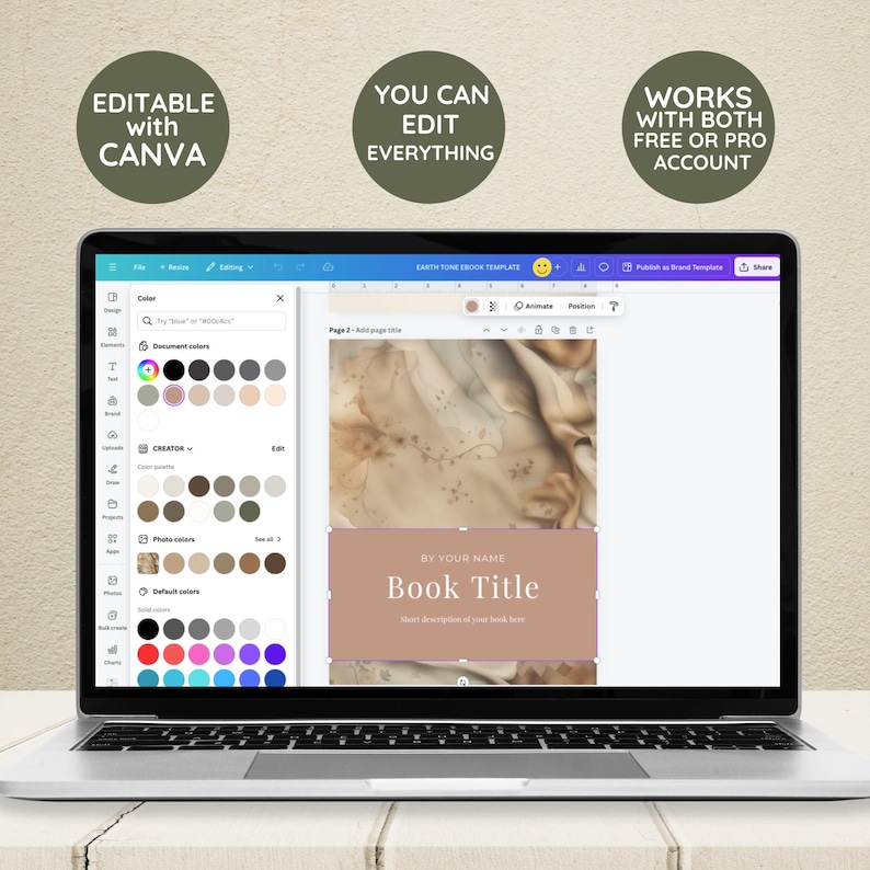 May include: A laptop screen displaying a Canva design template for an ebook cover. The template features a beige background with a subtle marble pattern and a text box that says "BY YOUR NAME Book Title". The text box is a light brown color with a pink outline. The template is editable with Canva.