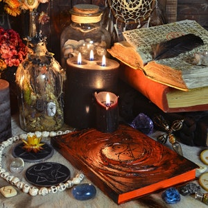 a table topped with lots of books and candles