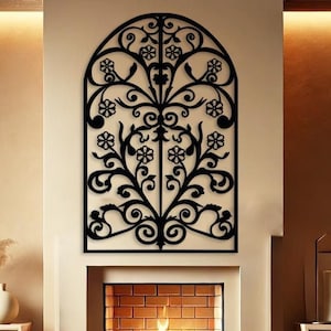 May include: A black metal wall decoration featuring a floral design, positioned above a fireplace in a living room. The fireplace has a brick surround and a fire burning within.