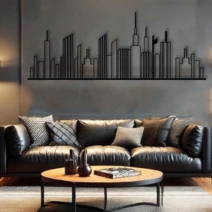 May include: A black metal wall art sculpture depicting a city skyline. The sculpture is mounted on a gray wall above a black leather sofa and a wooden coffee table.