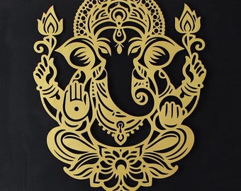 May include: Gold-coloured metal wall decor featuring a detailed cutout of the Hindu deity Ganesha. The design includes intricate floral patterns and a traditional headdress.