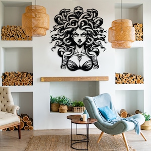May include: Black and white wall art featuring a stylized illustration of Medusa, a mythical Greek figure with snakes for hair. The art is displayed in a living room setting with a fireplace, furniture, and plants.
