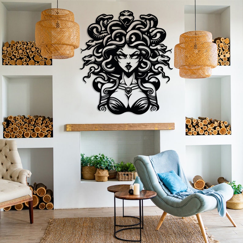 May include: Black and white wall art featuring a stylized illustration of Medusa, a mythical Greek figure with snakes for hair. The art is displayed in a living room setting with a fireplace, furniture, and plants.