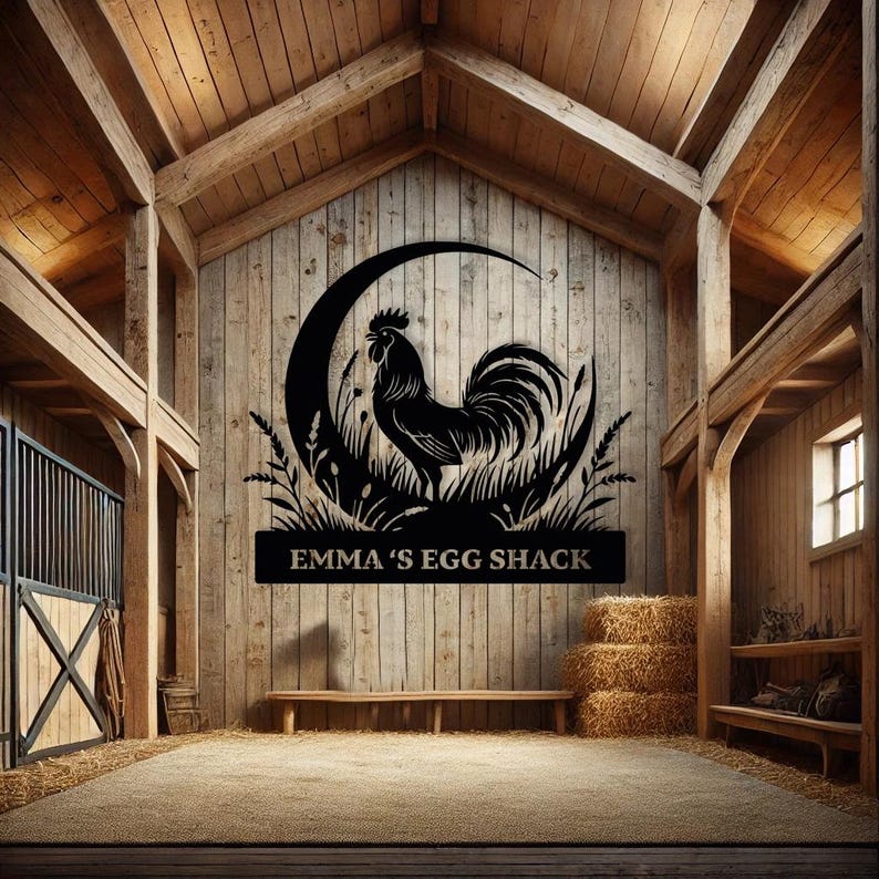 May include: Black metal rooster silhouette with a crescent moon and grass design, mounted on a wooden barn wall. The text "EMMA'S EGG SHACK" is below the rooster. The barn interior has a rustic aesthetic with hay bales and a bench.