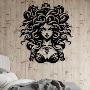 May include: Black and white silhouette of Medusa, a mythical Greek figure with snakes for hair, a fierce expression, and a bare chest.