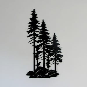 May include: Black metal silhouette wall art featuring three pine trees with a bird perched on a rock at the base.