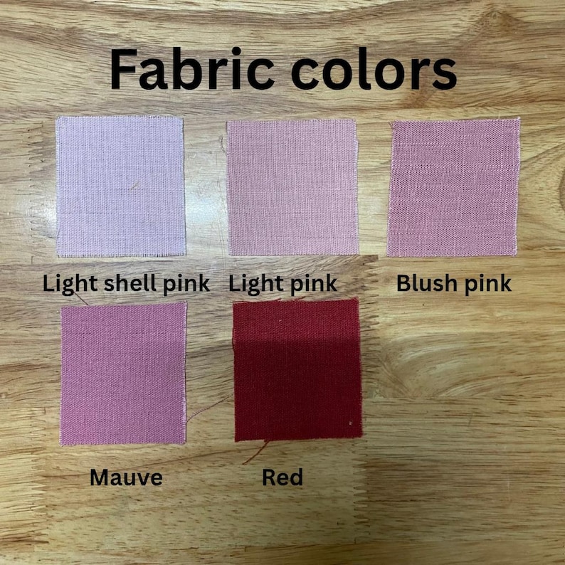 May include: Image displaying fabric samples in shades of pink and red. The swatches are labelled: Light shell pink, Light pink, Blush pink, Mauve, and Red. The text "Fabric colours" is at the top.