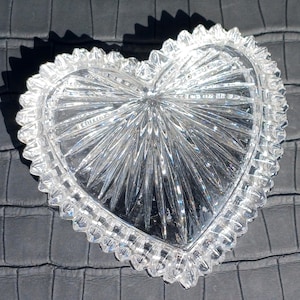 Crystal heart dish open on dark background showing cut pattern details.