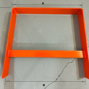 May include: Orange metal stand with a rectangular frame and a horizontal bar. The stand is 24 inches wide, 16 inches tall, and 10 inches deep.