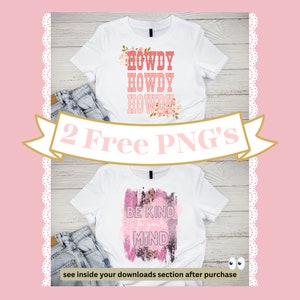 May include: Two white t-shirts with graphic designs. The first shirt has a pink, red, and white design with the text "HOWDY HOWDY HOWDY". The second shirt has a pink and white design with the text "BE KIND TO YOUR MIND".