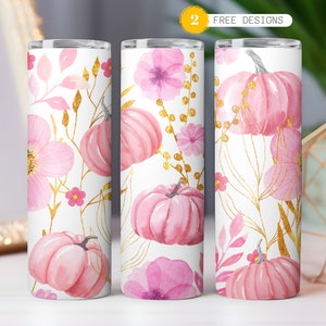 May include: Two pink and gold watercolor tumbler designs featuring pumpkins and flowers. The tumblers are white with a pink and gold floral pattern and have a gold rim.