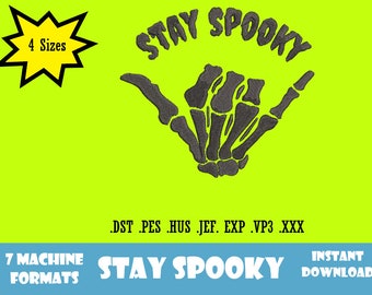 May include: A digital embroidery design featuring a skeleton hand making the "hang loose" gesture with the text "STAY SPOOKY" above it. The design is available in 4 sizes and 7 machine formats.