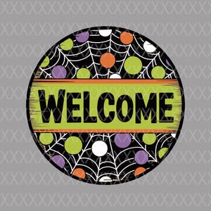 May include: Round Halloween-themed sign with a black background featuring white spiderwebs and colorful polka dots in orange, green, purple, and white. The word "WELCOME" is displayed in large black letters on a green and orange banner.