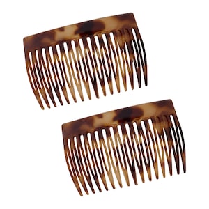 May include: Two brown tortoiseshell hair combs with a wide tooth design.
