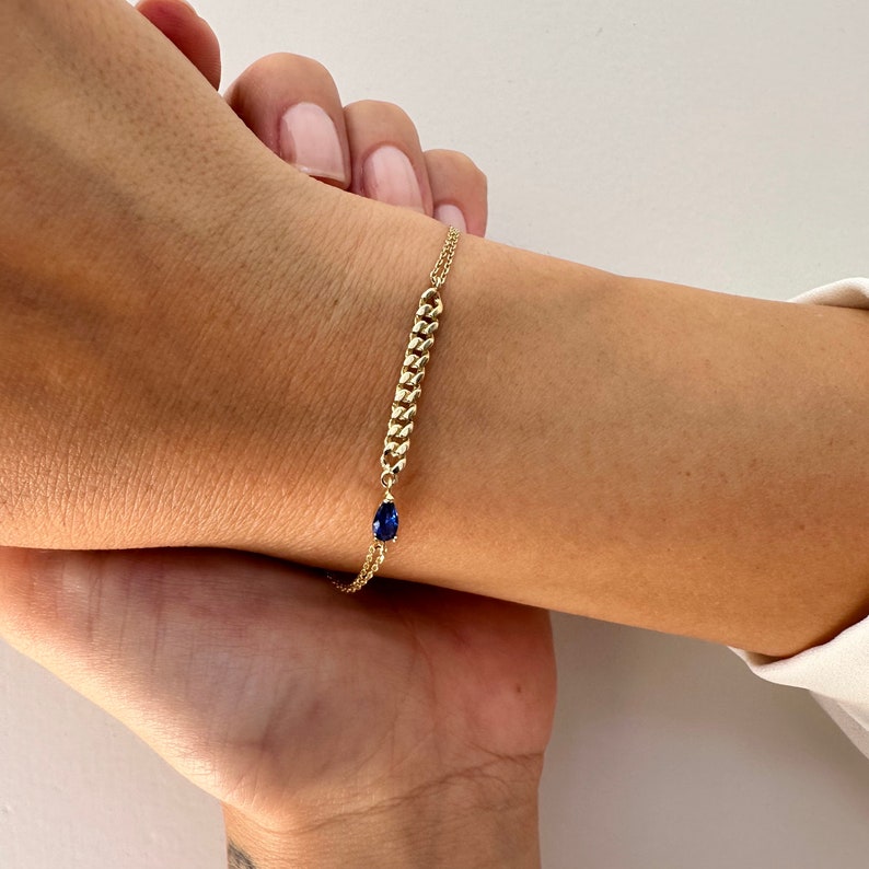 Sapphire raindrop gemstone bracelet with a fine chain and a piece of gourmet chain in the center attached to the sapphire raindrop. Birthstone bracelet for semptember.