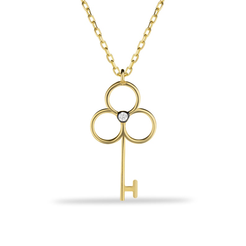 14K dainty gold key necklace with a fine chain. There is a little zircon in the middle of the handle of the key. It is available in three different color options.