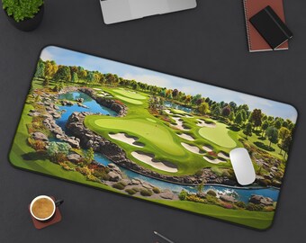 May include: A rectangular mousepad featuring a detailed image of a golf course with green fairways, sand traps, and a water feature. The design includes trees, a blue sky, and a red flag on the green. A white mouse is on the pad.