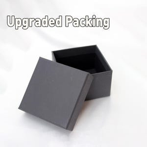 May include: An open, gray cardboard box with a lid. The box is empty and ready for packaging.