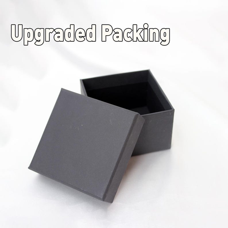 May include: An open, gray cardboard box with a lid. The box is empty and ready for packaging.