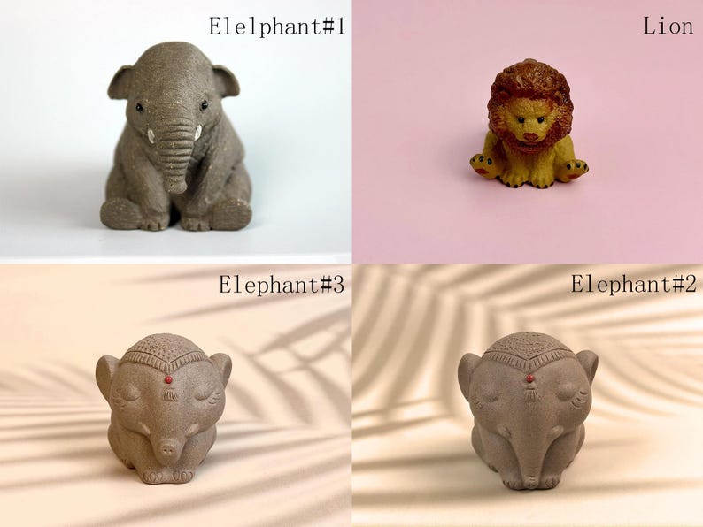 May include: Four small ceramic animal figurines: a gray elephant, a gray elephant with a red dot on its forehead, a gray elephant with a red dot on its forehead, and a brown lion. The elephants are in a sitting position, while the lion is sitting with its paws outstretched. The figurines are on a variety of surfaces, including a white surface, a pink surface, and a brown surface.