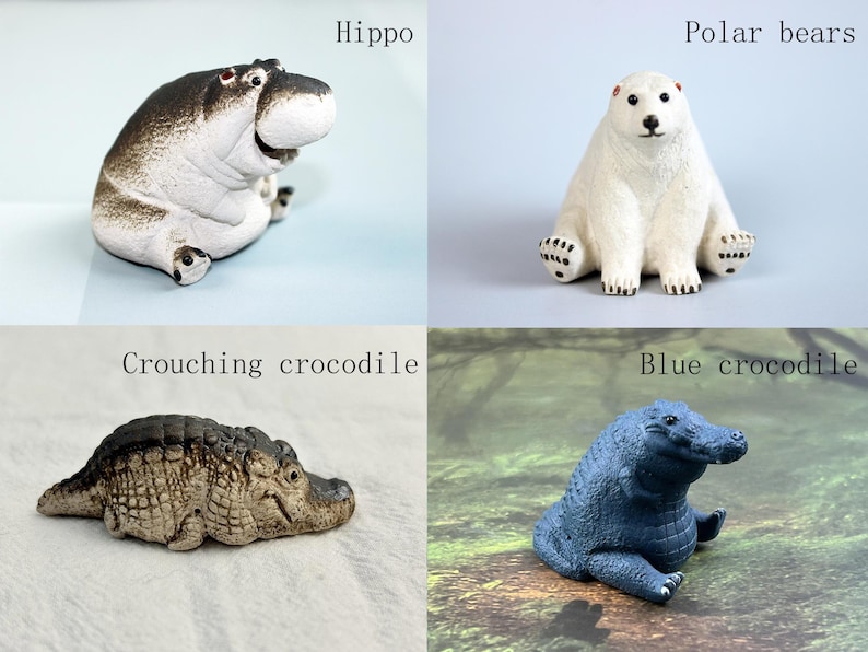 May include: Four ceramic animal figurines: a hippopotamus, a polar bear, a crouching crocodile, and a blue crocodile. The hippopotamus is brown and white, the polar bear is white, the crouching crocodile is brown and green, and the blue crocodile is blue.