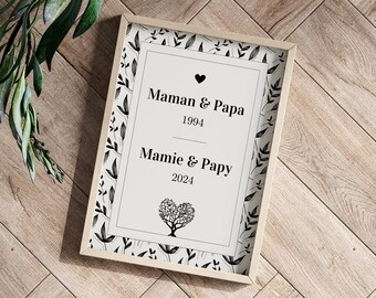 May include: A framed print with a white background and black text. The text reads "Maman & Papa 1994" and "Mamie & Papy 2024". A black heart with a tree inside is below the text.