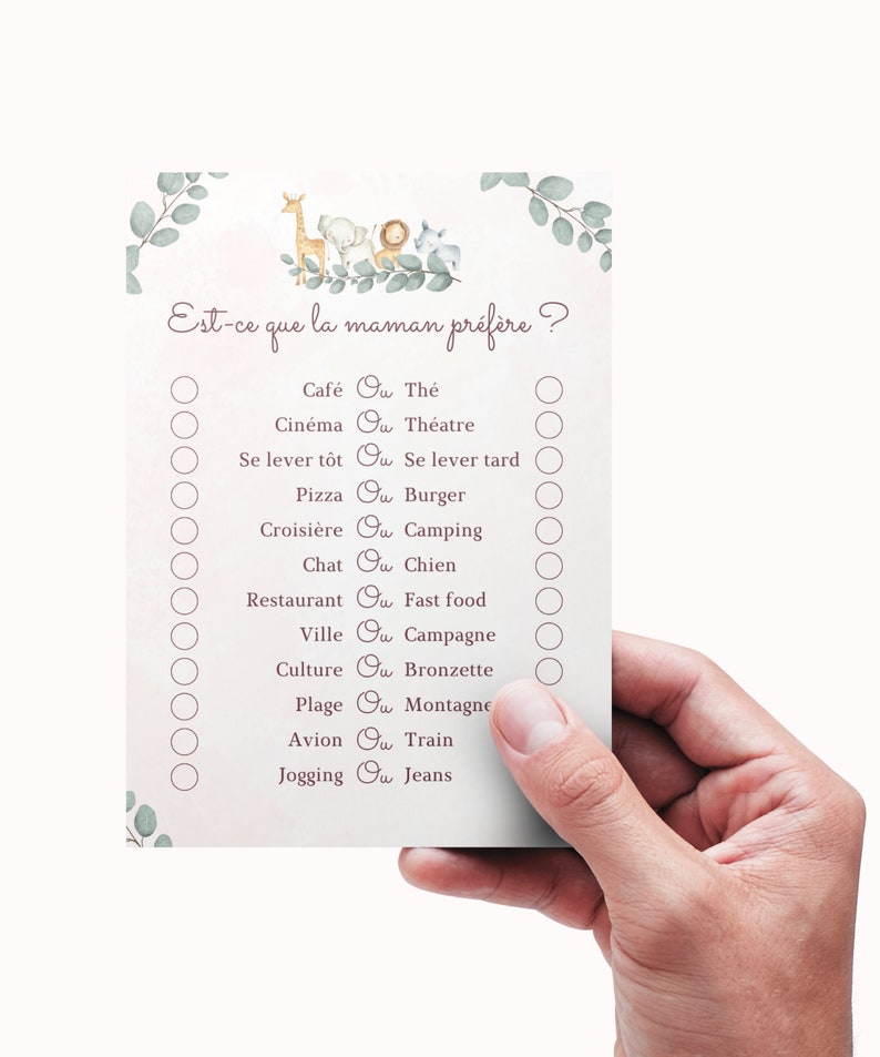 May include: A pink and white baby shower game card with the text "Est-ce que la maman pr&eacute;f&egrave;re?" and a list of questions with two options each. The options are separated by the word "Ou". The card features a cartoon illustration of a giraffe, elephant, lion, and monkey.