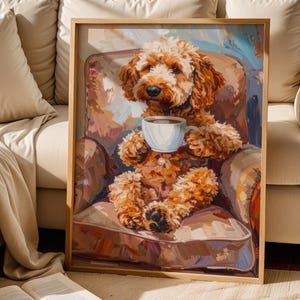 May include: A framed art print shows a brown dog in an armchair, holding a white teacup. The artwork uses a warm colour palette with brown, beige, and blue tones. The dog's fur is detailed, and the style is painterly. The print is in a wooden frame.