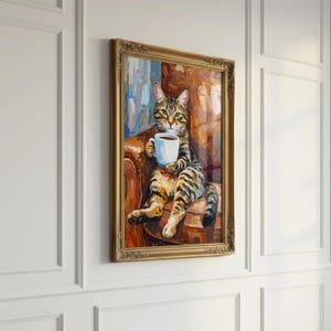 May include: Oil painting of a tabby cat seated in a brown armchair, holding a white mug of coffee. The cat is depicted with green eyes and a relaxed posture. The artwork is framed in a gold ornate frame, adding a touch of elegance.