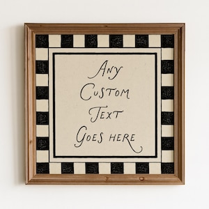 May include: A square wall sign in a brown wooden frame featuring a cream-colored center with the black handwritten text Any Custom Text Goes Here. The sign is bordered by a black and cream checkered pattern, creating a distinct visual frame.