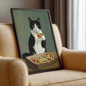 May include: Framed art print featuring a tuxedo cat enjoying a slice of pizza. The cat, with black and white fur, is holding a pizza slice. A pizza box with more pizza slices is in front of the cat. The background is a muted green.