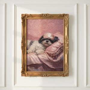 May include: A framed painting of a small dog wearing a pink sleep mask, resting on a pink pillow and bedding. The dog has black and white fur. The painting is in an ornate gold frame.