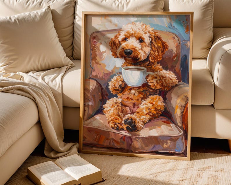 May include: A framed art print shows a brown dog in an armchair, holding a white teacup. The artwork uses a warm colour palette with brown, beige, and blue tones. The dog's fur is detailed, and the style is painterly. The print is in a wooden frame.