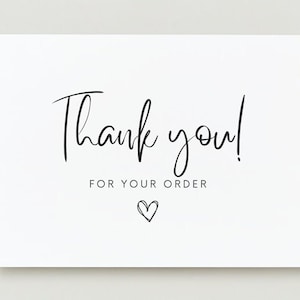 May include: A white card with the words "Thank you!" in elegant black script. Below, the text "FOR YOUR ORDER" is printed, accompanied by a small heart illustration. The design is simple and conveys gratitude.