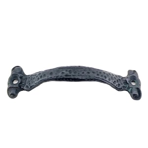 May include: A dark gray, hammered metal handle with a curved design. The handle has a textured surface and is designed with two mounting points on each end. The handle is approximately 5 inches long.