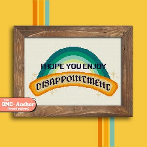 May include: Cross stitch pattern featuring a rainbow with the text "I hope you enjoy disappointment".