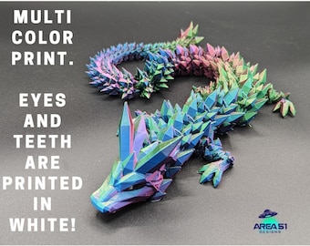 May include: A multi-color 3D printed dragon with iridescent scales. The eyes and teeth are printed in white.  "MULTI COLOR PRINT. EYES AND TEETH ARE PRINTED IN WHITE!" text is visible in the image. AREA 51 DESIGNS is also visible in the image.